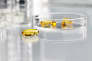 vitamins pills omega 3 supplements with petri dish